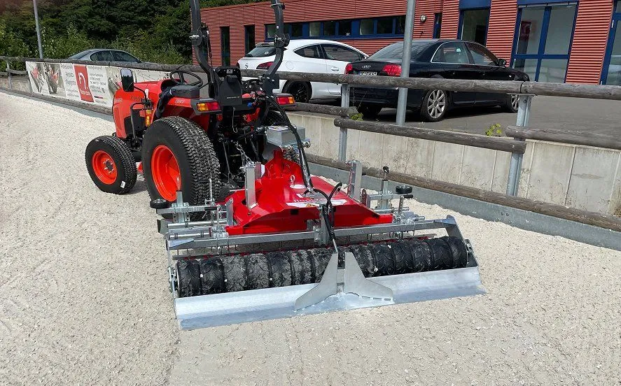 Floor-Care PREMIUM achter een rode compacte trekker in een buitenbak